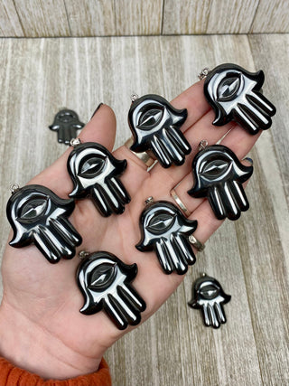 Hematite Hamsa Pendant from Curious Muse Crystals Tagged with crystal jewelry, evil eye, Hamsa, hematite, Pendant, protection, protection charm, protection necklace