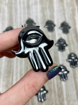 Hematite Hamsa Pendant from Curious Muse Crystals Tagged with crystal jewelry, evil eye, Hamsa, hematite, Pendant, protection, protection charm, protection necklace