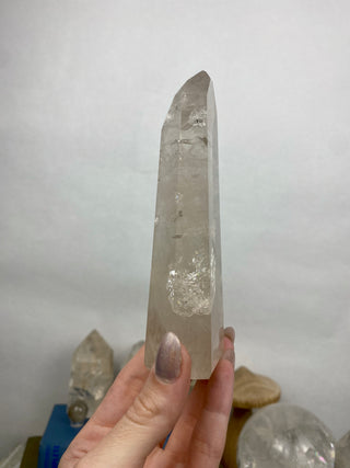 Lemurian Quartz Polished Tower | Wispy Inclusions | Six Side Generator from Curious Muse Crystals Tagged with clear, clear brazil quartz, clear quartz, Crown crystal, hide-notify-btn, lemurian, lemurian generator, Lemurian Quartz, lemurian seed, quartz, rainbow, sunset mine, tower