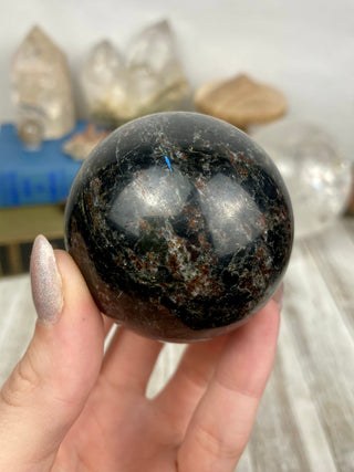 Astrophyllite with Garnet Sphere from Curious Muse Crystals Tagged with astrophyllite, black, blue, garnet, gold, hide-notify-btn, high quality, red, sphere