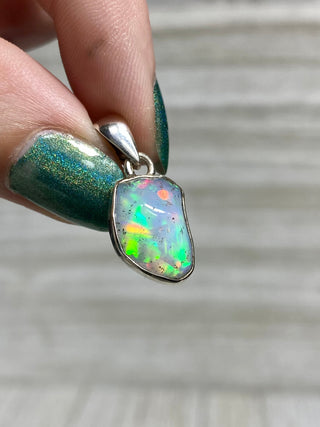 Welo Opal Raw Form in Sterling Silver Pendant from Curious Muse Crystals Tagged with crystal healing, Crystal Jewelry, energy work, Ethiopian opal, flashy opal, hide-notify-btn, october crystal, opal crystal pendant, rainbow, reiki crystal, Sterling, sterling silver, Welo Opal, white opal pendant, witchy jewelry