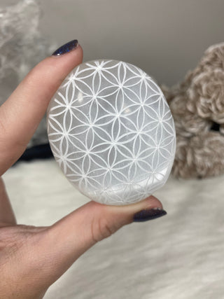 Selenite Etched Flower of Life Palm Stone | Cleansing from Curious Muse Crystals Tagged with aura cleansing, beginner crystal, cleansing, cleansing crystal, clear, crown chakra, crystal healing, crystal magic, energy work, genuine crystal, hand crystal, palm stone, palmstone, polished, selenite, soothing stone, white