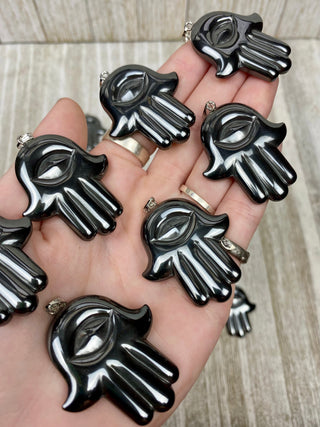 Hematite Hamsa Pendant from Curious Muse Crystals Tagged with crystal jewelry, evil eye, Hamsa, hematite, Pendant, protection, protection charm, protection necklace