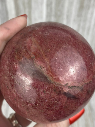 Rhodonite Sphere from Madagascar from Curious Muse Crystals Tagged with crystal, crystal energy, crystal sphere, hide-notify-btn, madagascar, palm stone, palmstone, pink, polished, red, reiki healing, Rhodonite, sphere