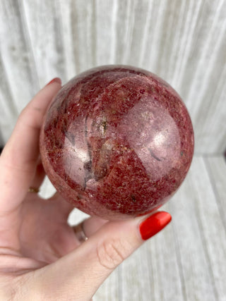 Rhodonite Sphere from Madagascar from Curious Muse Crystals Tagged with crystal, crystal energy, crystal sphere, hide-notify-btn, madagascar, palm stone, palmstone, pink, polished, red, reiki healing, Rhodonite, sphere
