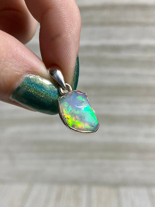 Welo Opal Raw Form in Sterling Silver Pendant from Curious Muse Crystals Tagged with crystal healing, Crystal Jewelry, energy work, Ethiopian opal, flashy opal, hide-notify-btn, october crystal, opal crystal pendant, rainbow, reiki crystal, Sterling, sterling silver, Welo Opal, white opal pendant, witchy jewelry