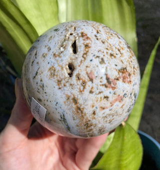 Ocean Jasper Sphere with Druzy Pockets from Curious Muse Crystals Tagged with Crystal healing, drusy pocket, hide-notify-btn, jasper, Madagascar mineral, mineral collection, natural mineral, ocean jasper, Orbicular jasper, peace and calming, purple, reiki healing, sphere, white, yellow