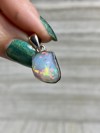 Welo Opal Raw Form in Sterling Silver Pendant from Curious Muse Crystals Tagged with crystal healing, Crystal Jewelry, energy work, Ethiopian opal, flashy opal, hide-notify-btn, october crystal, opal crystal pendant, rainbow, reiki crystal, Sterling, sterling silver, Welo Opal, white opal pendant, witchy jewelry