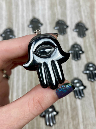 Hematite Hamsa Pendant from Curious Muse Crystals Tagged with crystal jewelry, evil eye, Hamsa, hematite, Pendant, protection, protection charm, protection necklace