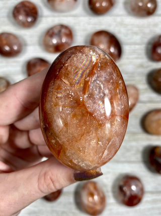 Hematite in Quartz Palm Stone from Curious Muse Crystals Tagged with carving, clear, crystal, hematite, hematite red quartz, hematoid quartz, orange, palm stone, palmstone, polished, quartz