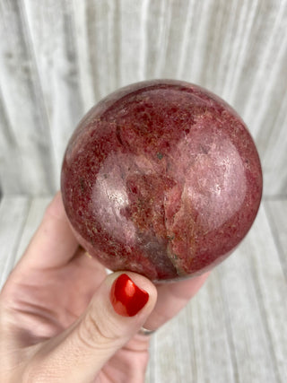 Rhodonite Sphere from Madagascar from Curious Muse Crystals Tagged with crystal, crystal energy, hide-notify-btn, madagascar, palm stone, palmstone, pink, polished, red, reiki healing, Rhodonite