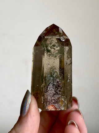 Smoky Quartz with Chlorite Phantoms - Polished Tower - Six Side Generator from Curious Muse Crystals for 38. Tagged with brown, Crystal decor, Crystal healing, genuine crystal, green, hide-notify-btn, high quality natural, Lemurian Quartz, Lemurian seed, mineral collection, natural mineral, quartz, reiki healing, smoky quartz, tower