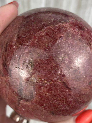 Rhodonite Sphere from Madagascar from Curious Muse Crystals Tagged with crystal, crystal energy, hide-notify-btn, madagascar, palm stone, palmstone, pink, polished, red, reiki healing, Rhodonite