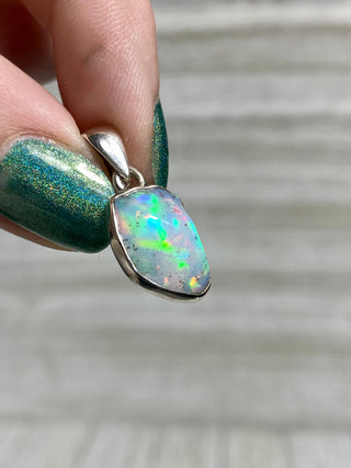 Welo Opal Raw Form in Sterling Silver Pendant from Curious Muse Crystals Tagged with crystal healing, Crystal Jewelry, energy work, Ethiopian opal, flashy opal, hide-notify-btn, october crystal, opal crystal pendant, rainbow, reiki crystal, Sterling, sterling silver, Welo Opal, white opal pendant, witchy jewelry
