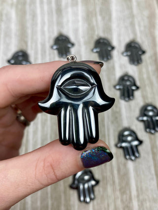 Hematite Hamsa Pendant from Curious Muse Crystals Tagged with crystal jewelry, evil eye, Hamsa, hematite, Pendant, protection, protection charm, protection necklace
