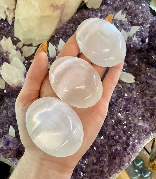 Selenite Gypsum Palm Stone - Cleansing from Curious Muse Crystals for 15.00. Tagged with aura cleansing, beginner crystal, cleansing, cleansing crystal, crown chakra, crystal healing, crystal magic, energy work, genuine crystal, hand crystal, palm stone, palmstone, selenite, soothing stone