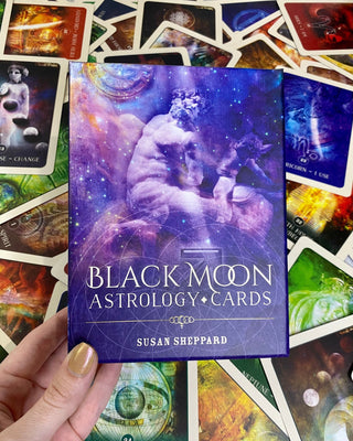 Black Moon Astrology Oracle Deck | Alternative Divination from Blue Angel Inc Tagged with alternative tarot, astrology oracle, black moon, colorful tarot, divination tool, intuitive divination, large cards, modern witch, oracle, simple oracle deck, surreal tarot, tarot deck, throat chakra, with guidebook