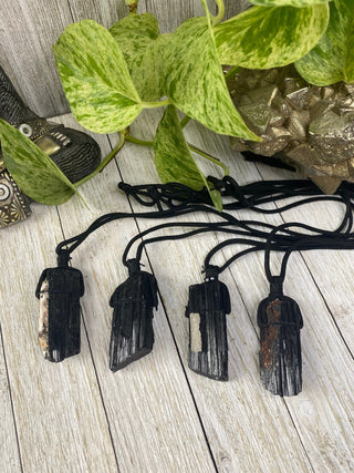 Black Tourmaline on Cord Necklace | Protection Crystal Jewelry from Curious Muse Crystals for 9. Tagged with black, crystal jewelry, crystal necklace, energy work, high vibration, light worker, mineral on cord, natural crystal, necklace, protection necklace, raw crystal, raw stone pendant, raw tourmaline, reiki healing, tourmaline