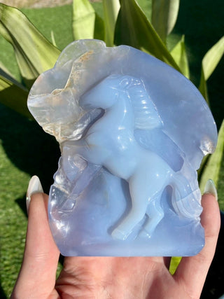 Blue Chalcedony Hand Carved Horse Geode from Curious Muse Crystals Tagged with animal carving, animal guide, blue, blue chalcedony, blue stone geode, calming crystal, chalcedony, Crystal carving, farmhouse decor, feng shui, hand carved geode, home decor stone, horse decor, horse head crystal, rearing horse statue, stone bird, western home decor