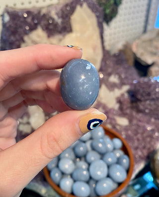 Angelite Tumbled Stone from Curious Muse Crystals for 2. Tagged with Angeline, angelite, anhydrite stone, blue, blue crystal, calming crystal, calming stone, cleansing crystal, communication stone, Crystal healing, genuine crystal, reiki work, throat chakra, tumbled stone