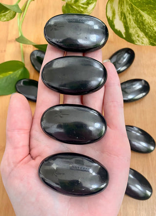 Shungite Palm Stone - Genuine Russian Shungite from Curious Muse Crystals Tagged with black, black palm stone, crystal healing, detox crystal, emf shield, genuine shungite, natural crystal palm, palm stone, palmstone, protection crystal, purification stone, reiki work, russian shungite, shungite, wifi protection