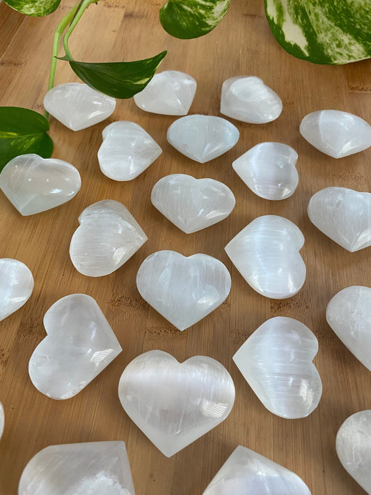 Selenite 2” Heart Stone - Satin Spar Gypsum - Cleansing from Curious Muse Crystals for 10.0. Tagged with aura cleansing, beginner crystal, cleansing crystal, crown chakra, crystal healing, crystal magic, energy work, genuine crystal, hand crystal, heart, palm stone, raw selenite, selenite, soothing stone
