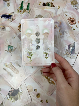 Astral Realms Crystal Oracle | Astrology Dreamscapes | Surrealism Art from Curious Muse Crystals for 24.95. Tagged with alternative tarot, astrology tarot, bright pastel art, crystal oracle, divination tool, feminine tarot, liminal space tarot, major arcana, minor arcana, surrealism tarot, tarot deck, throat chakra, with guidebook